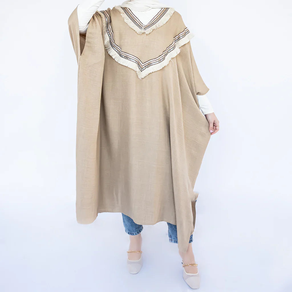 Enchanted V-Neck Cape in Turkish linen-cotton with imported Arabian taps and fluid drape, a striking free-size kaftan in beige, black, blue, or white