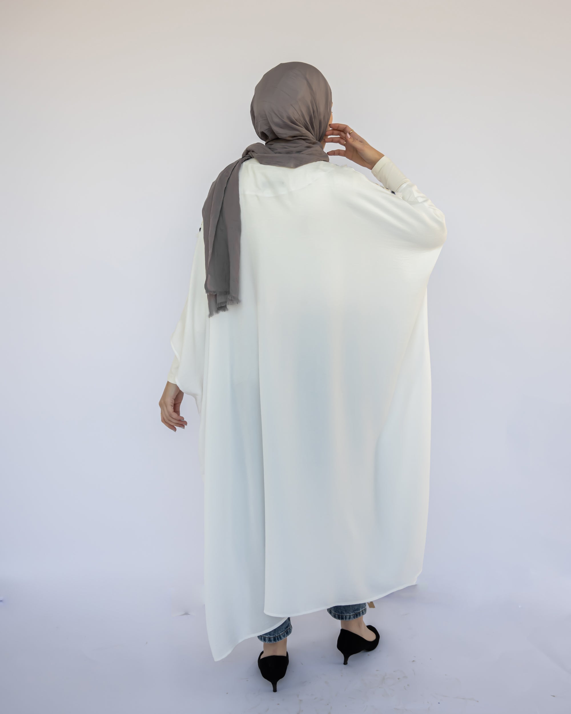 Enchanted V-Neck Cape in Turkish linen-cotton with imported Arabian taps and fluid drape, a striking free-size kaftan in beige, black, blue, or white