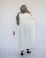 Enchanted V-Neck Cape in Turkish linen-cotton with imported Arabian taps and fluid drape, a striking free-size kaftan in beige, black, blue, or white