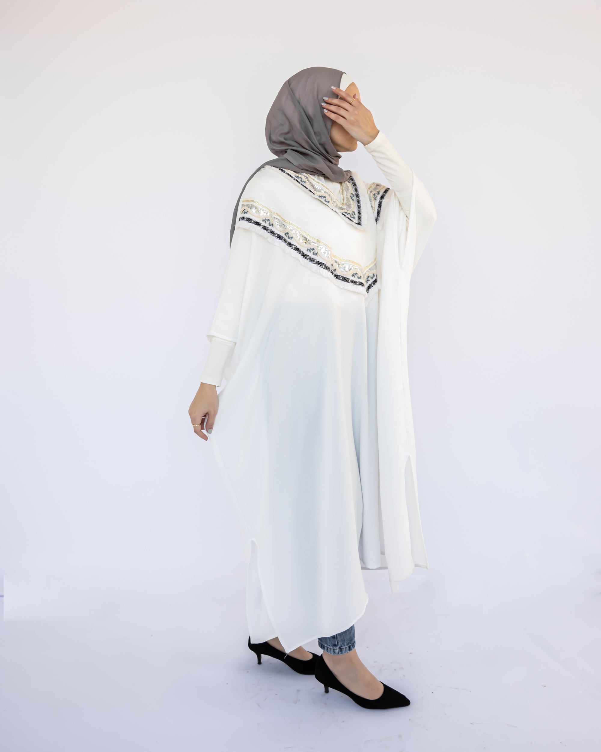 Enchanted V-Neck Cape in Turkish linen-cotton with imported Arabian taps and fluid drape, a striking free-size kaftan in beige, black, blue, or white