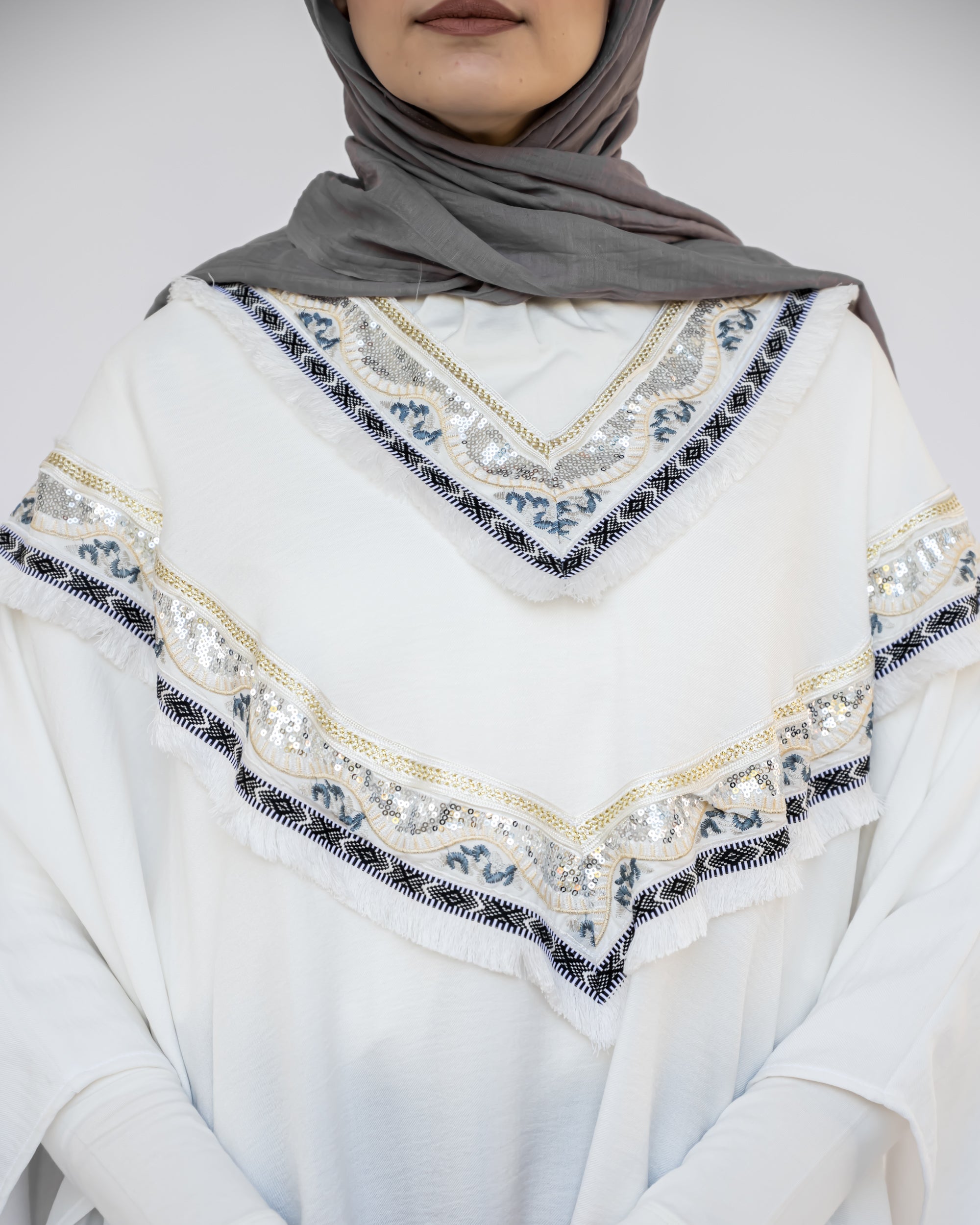 Enchanted V-Neck Cape in Turkish linen-cotton with imported Arabian taps and fluid drape, a striking free-size kaftan in beige, black, blue, or white