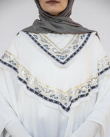 Enchanted V-Neck Cape in Turkish linen-cotton with imported Arabian taps and fluid drape, a striking free-size kaftan in beige, black, blue, or white