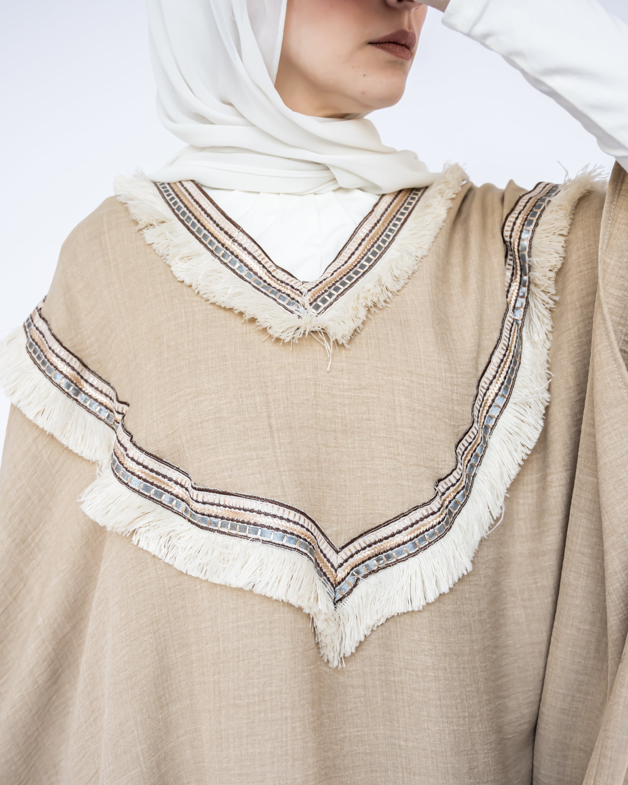 Enchanted V-Neck Cape in Turkish linen-cotton with imported Arabian taps and fluid drape, a striking free-size kaftan in beige, black, blue, or white