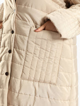 Long waterproof puffer coat with quilted texture and full coverage, ideal for modest winter wear in navy, beige, or grey