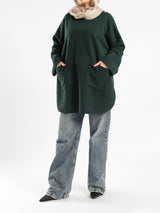 Oversized Pocketed Sweater in dark green, orange, gray, or green—relaxed fit with front pockets for bold winter layering
