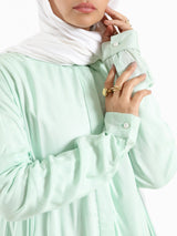 Ruffle Shirt in soft, breathable fabric with delicate frill accents, available in serene summer tones for a feminine modest look